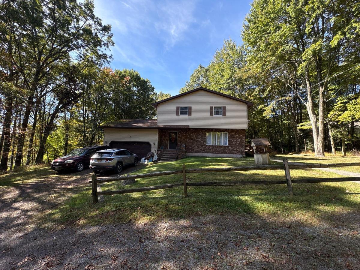 Dallas NY home before — split-level brick exterior
