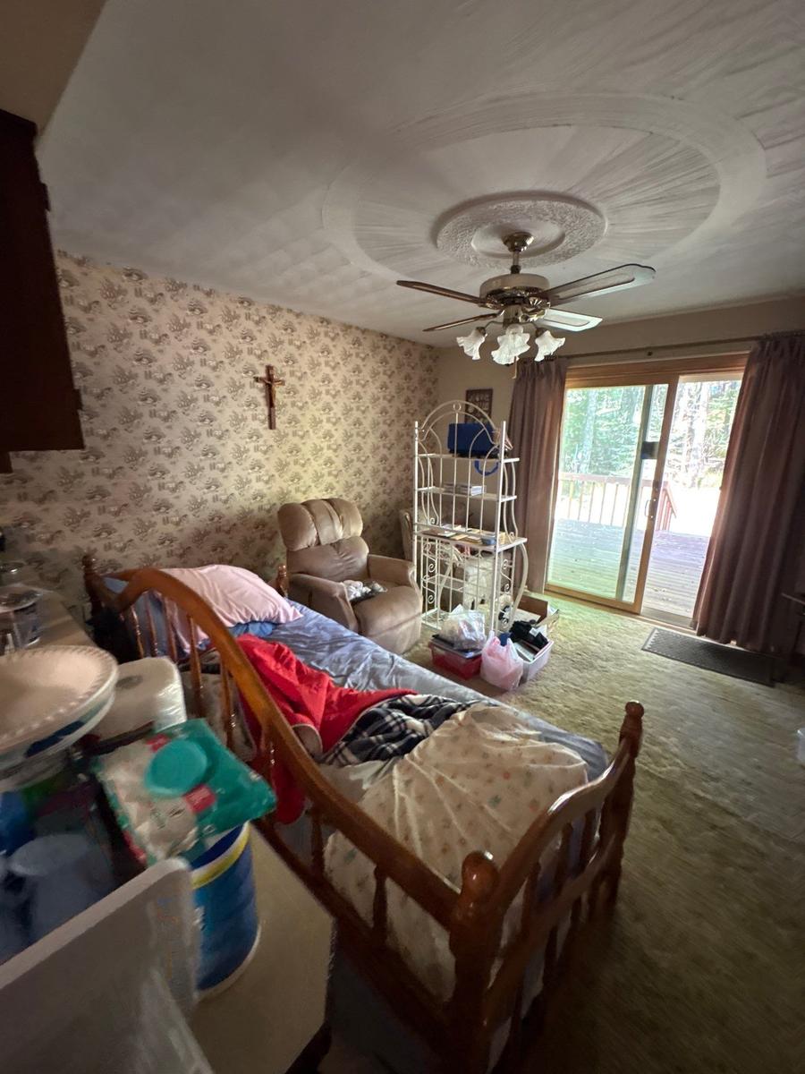 Dallas NY living room before — floral wallpaper, dated carpet, original condition
