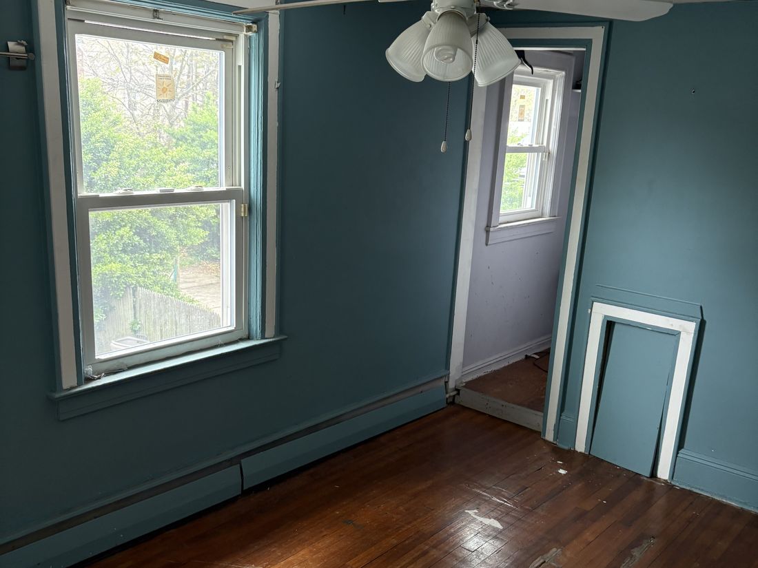 Bedroom with original hardwood flooring in the Hempstead, Long Island home