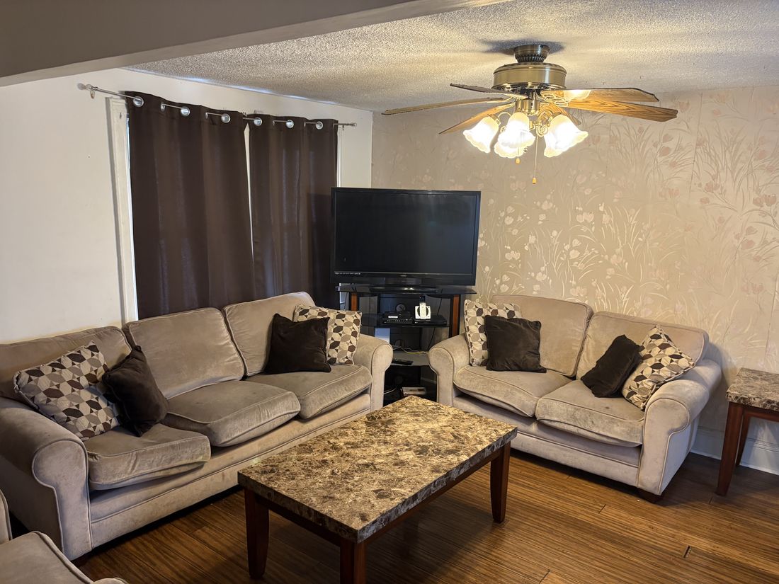 Living room with hardwood floors in the Hempstead colonial, photographed as purchased