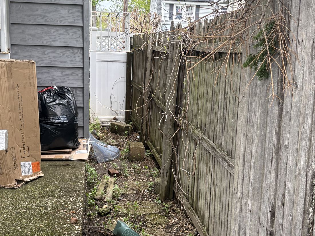 Deteriorated perimeter fencing along the property line at the Hempstead, NY home