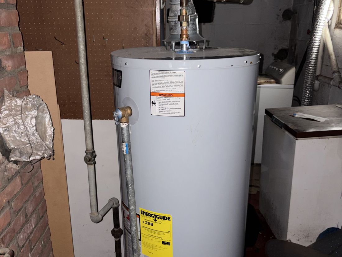 Updated water heater in the Hempstead basement — one of the systems already replaced