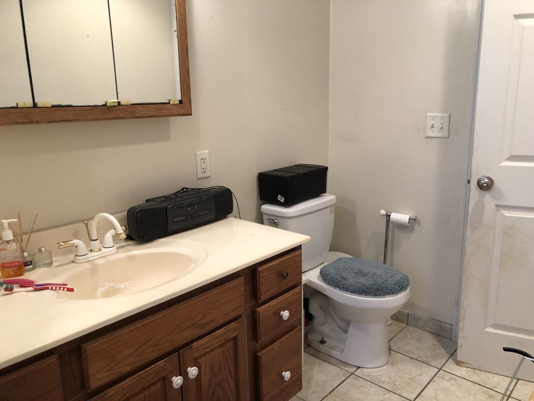 Second bathroom with original vanity and mirrored cabinet in the Holland Patent home