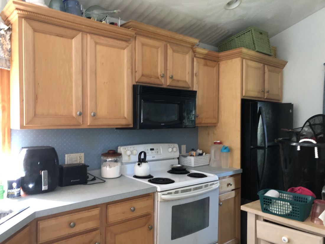 Original 1970s oak kitchen with dated appliances in the Holland Patent, NY ranch
