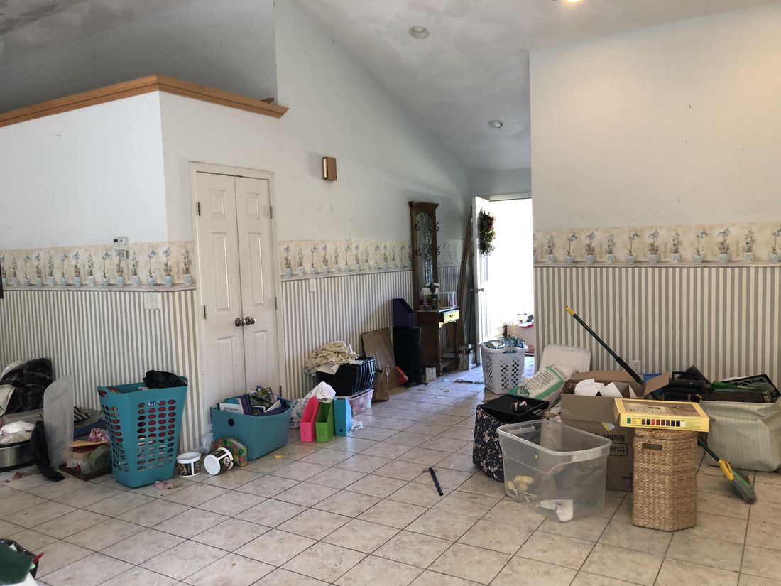 Second vaulted living space with original tile flooring and dated wall treatments