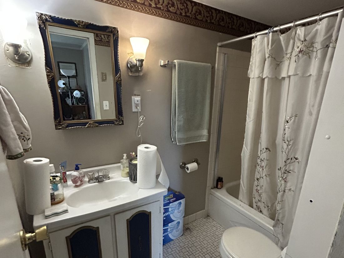 Original full bathroom with vanity and tub-shower in the West Babylon, Long Island home