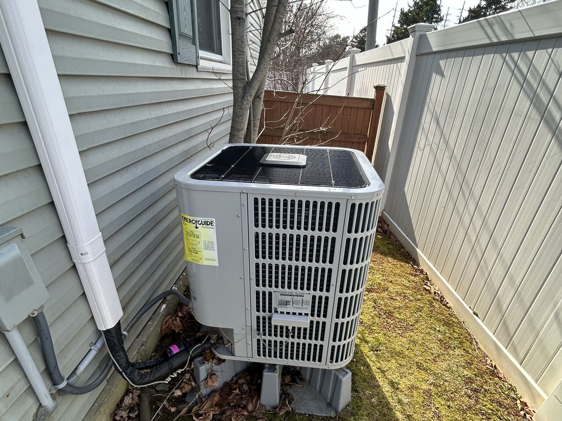 Newer exterior HVAC condenser unit at the West Babylon, NY property