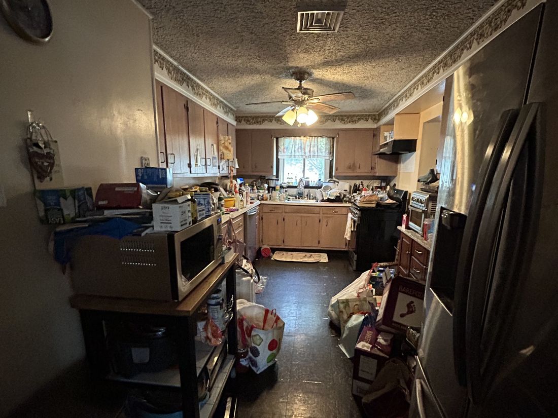 Second view of the kitchen and dining area showing the closed-off layout before renovation