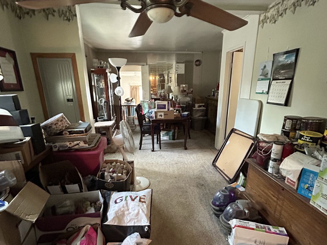 Living room divided from the dining area by a partition wall in the West Babylon home