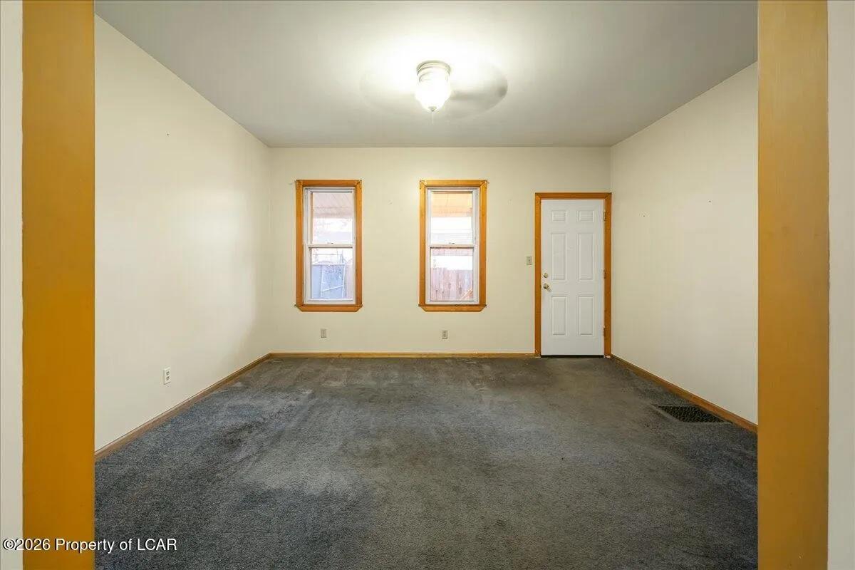 White Plains unit room after — neutral paint, cleaned, empty and ready
