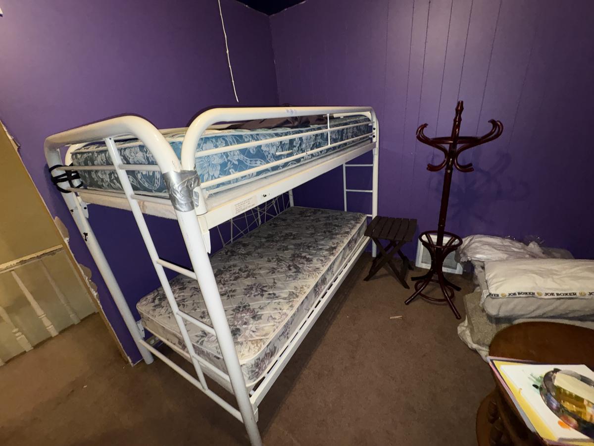 White Plains unit bedroom before — purple walls, bunk beds, occupied condition