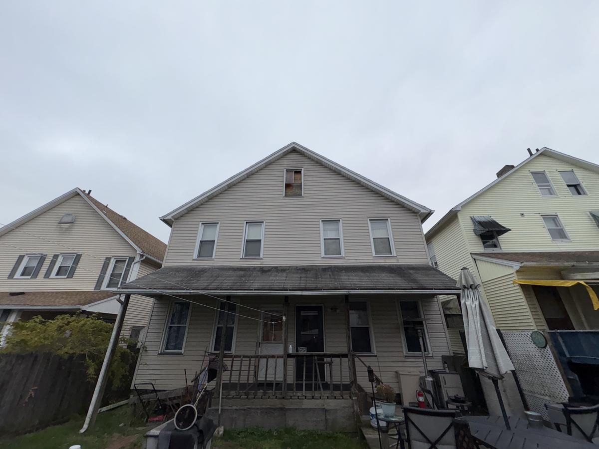 White Plains double before — two-unit vinyl siding exterior, covered porch