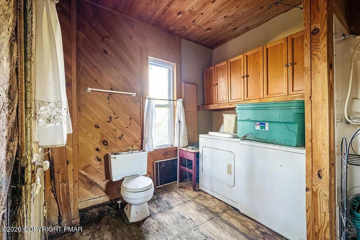 Victorian utility room after — pine ceiling, original cabinetry, washer dryer