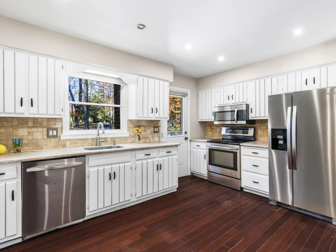 Renovated kitchen with white shaker cabinets, stone counters and stainless appliances in Yorktown Heights, NY