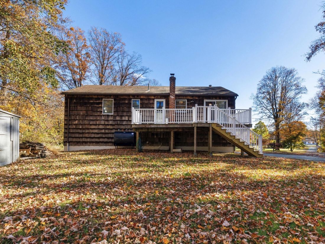 Rear elevation and rebuilt deck overlooking the one-acre Yorktown Heights lot