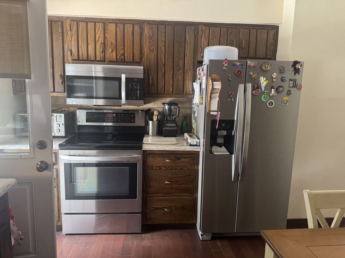 Original 1979 kitchen with dark wood cabinetry and panelling before renovation