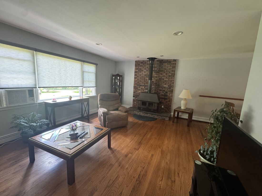 Living room with wood stove, still furnished, before the Yorktown Heights renovation